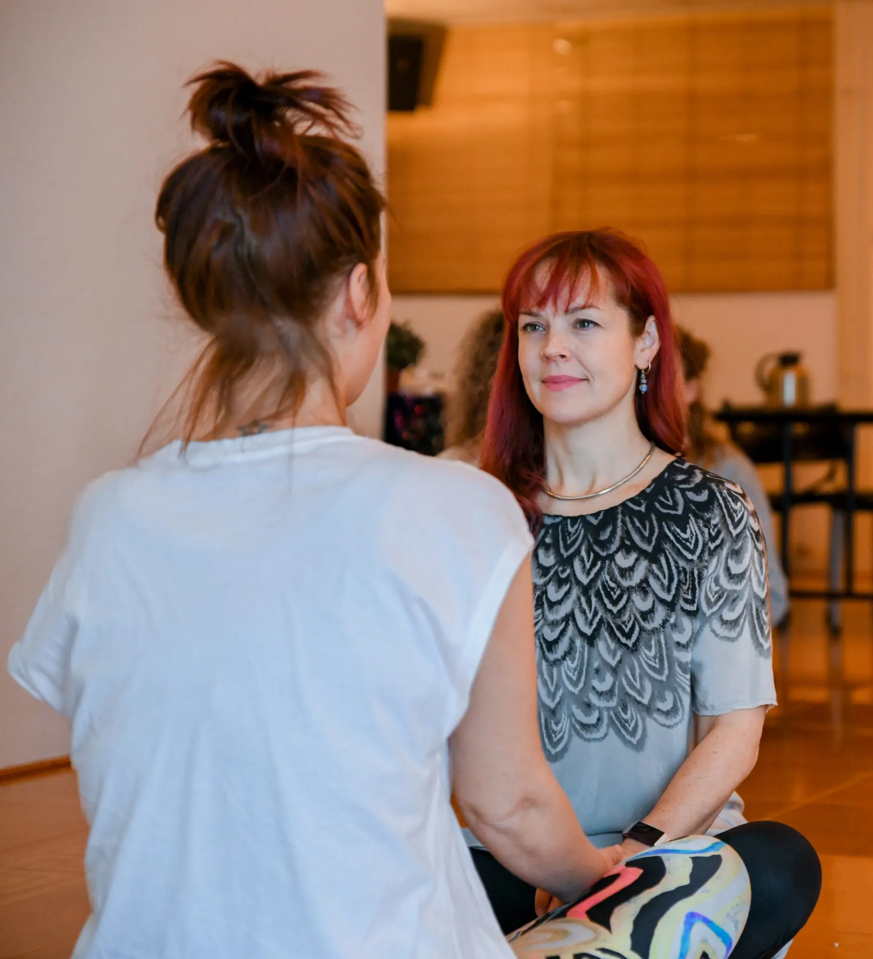 Two women listening closely to each other