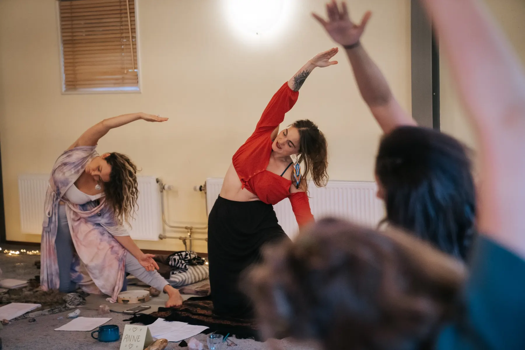Women stretching in a sunny room during Rise Up in Amsterdam